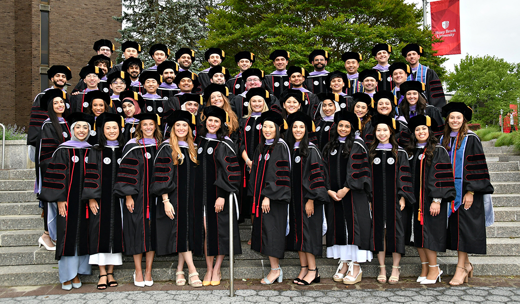 Forty-six members of the graduating class of 2025 in cap and gown