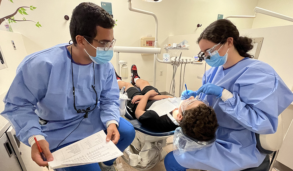 Dental students providing care for patient.