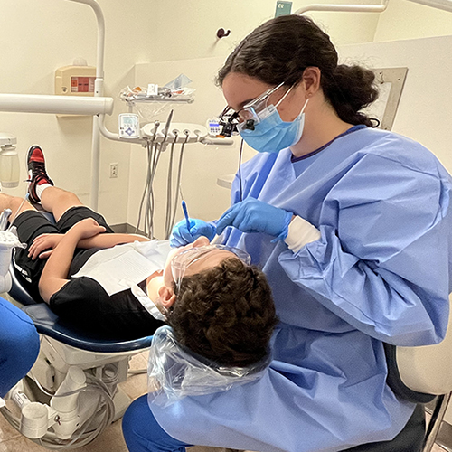 Dental students providing care for patient