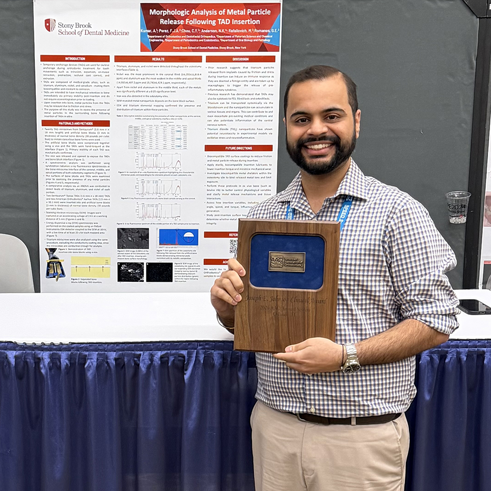 Arjun Kumar displaying his award at the 2026 AAO meeting
