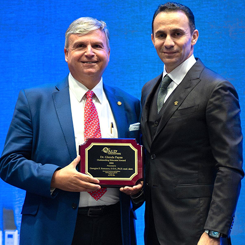 Georgios Romanos (left) accepting his award