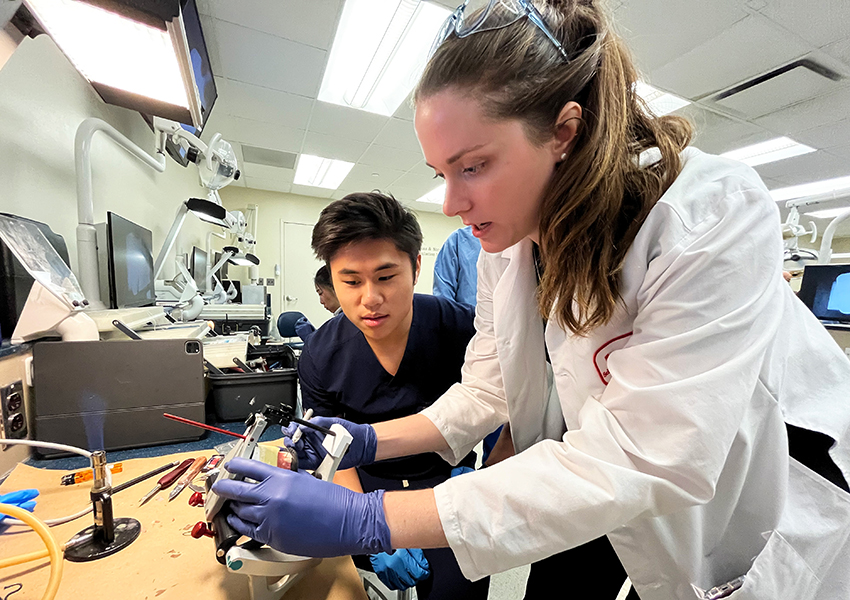 Dr. Patricia Swanson demonstrates the proper technique for a student.