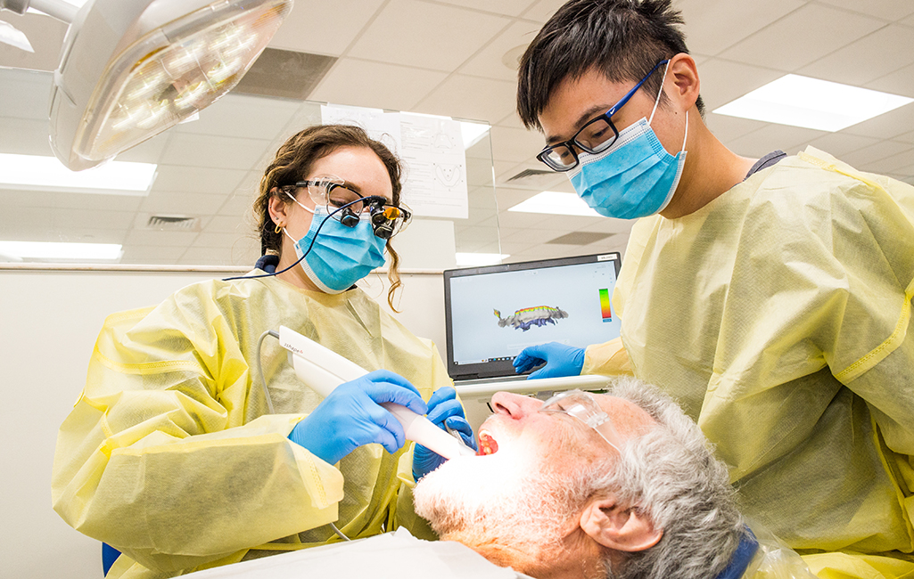 Faculty and student dentist providing care for a patient