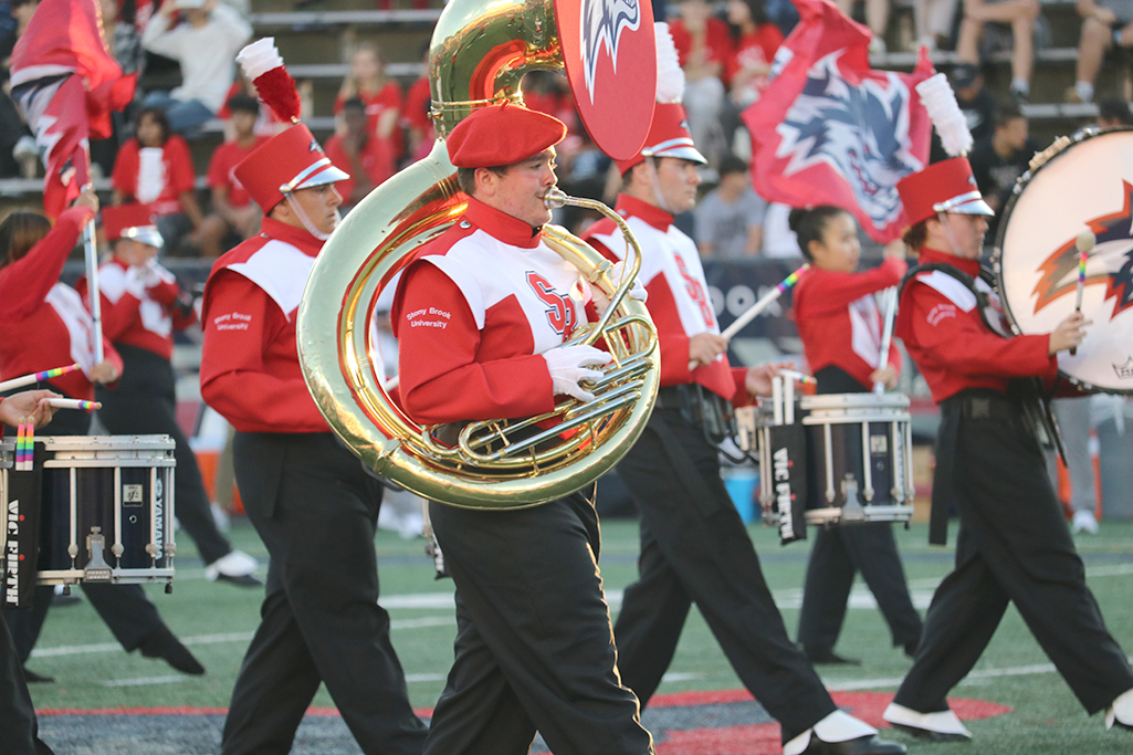 Stony Brook University tuba player with marching band mates