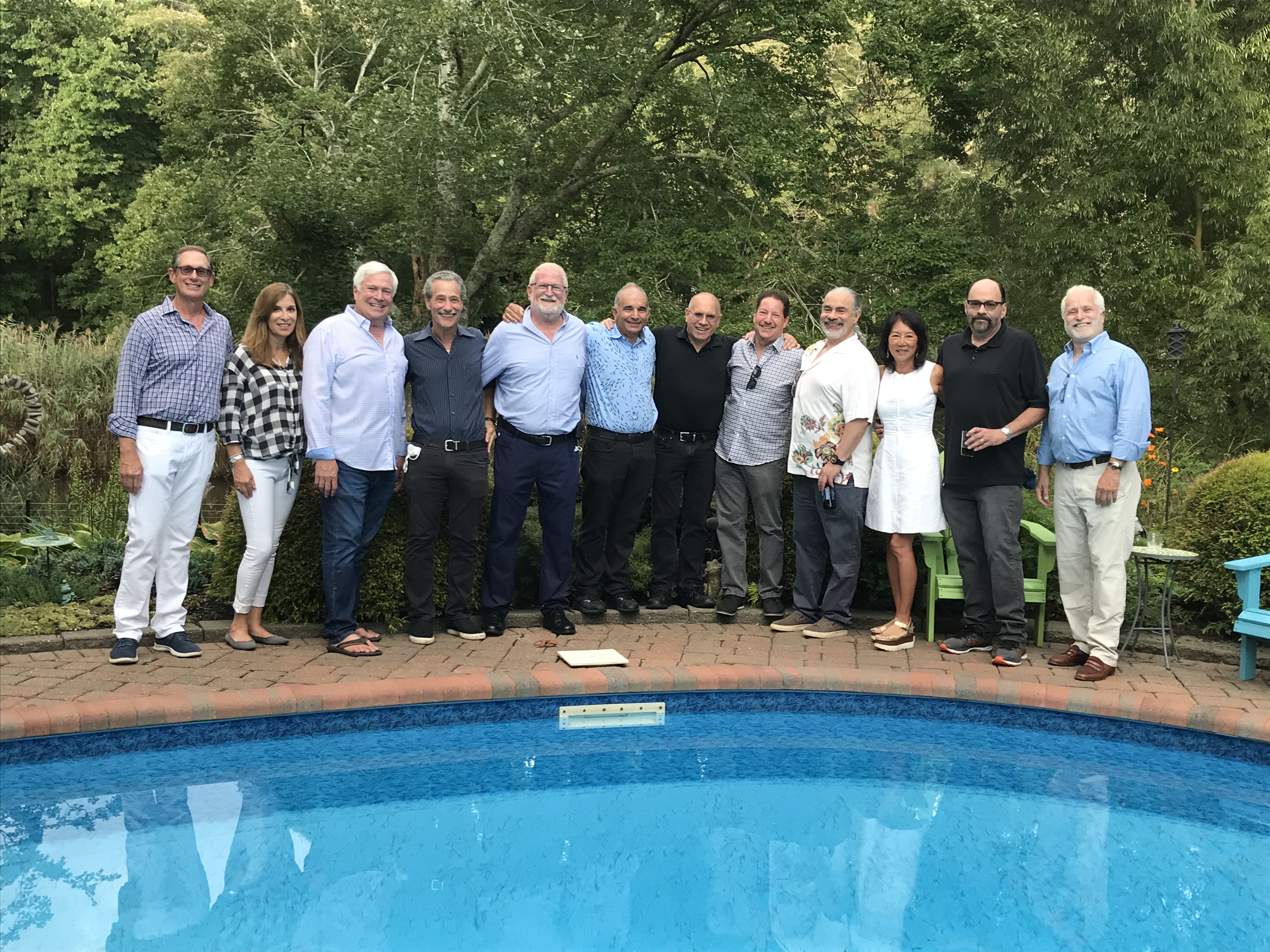 A group photo beside an outdoor swimming pool of members of the School of Dental Medicine's Class of 1981.