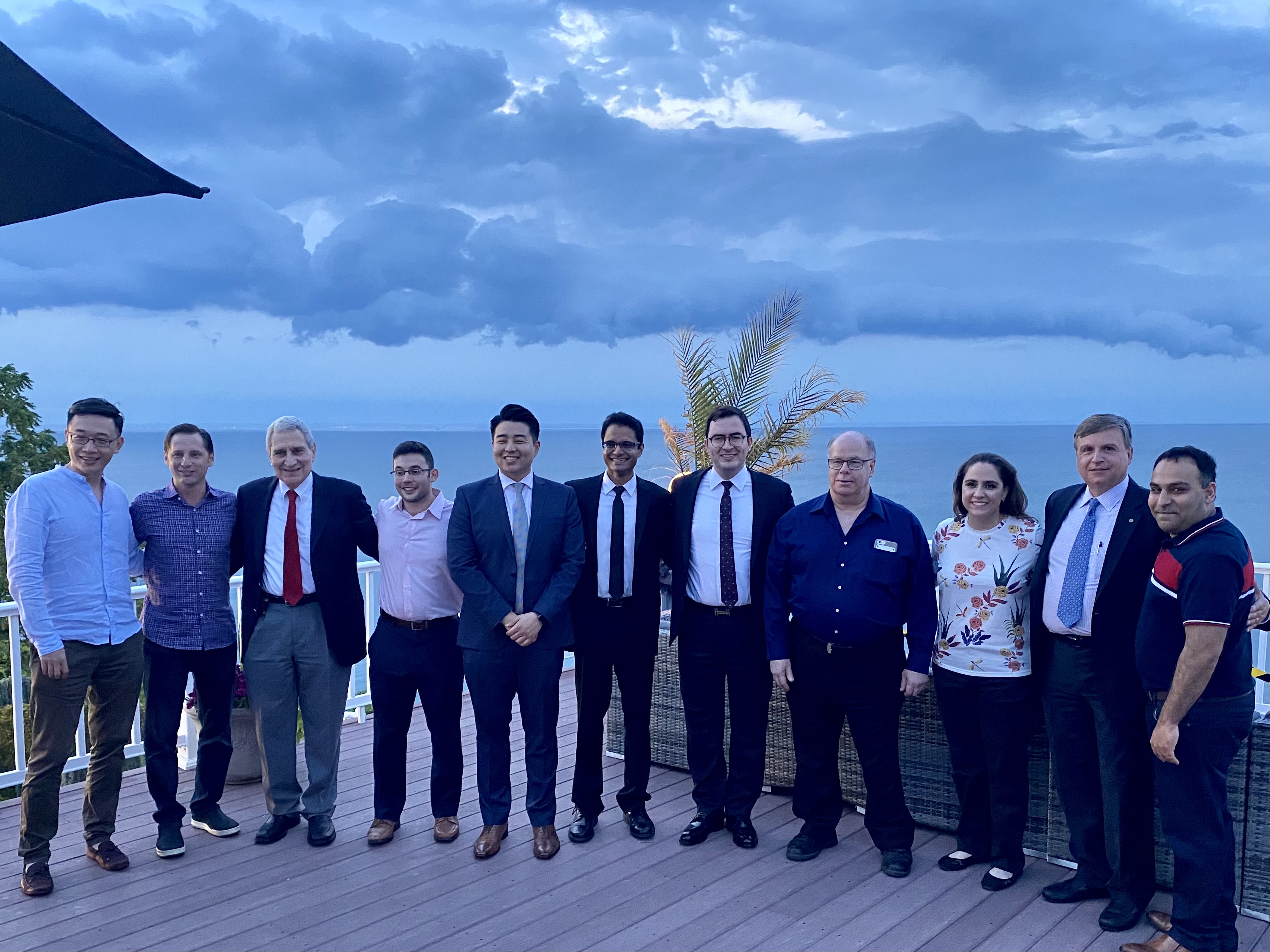 An outdoor group photo in front of the water of Stony Brook School of Dental Medicine's Department of Periodontology and students.