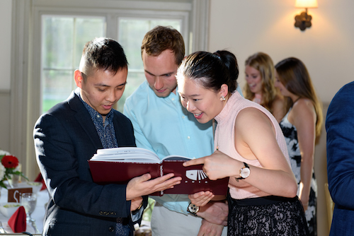 Class of 2018 Students Look Through Yearbook at Senior Celebration Dinner