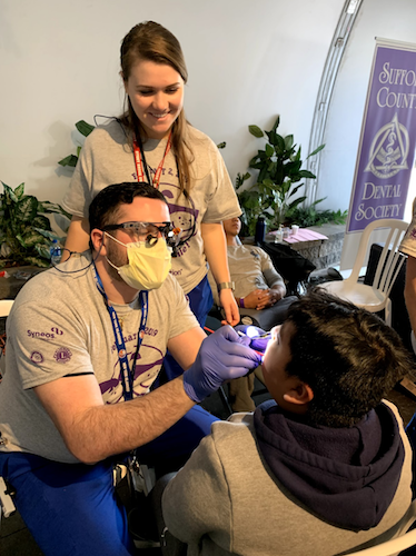A child receives a free oral health screening from Stony Brook School of Dental Medicine students in Riverhead, New York