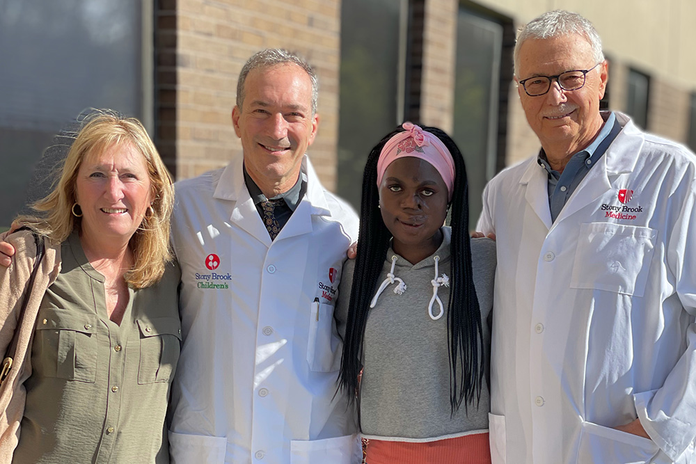 A group photo featuring Saline Atieno (second from right) with (from left) host Kerri Tame, Alexander Dagum, MD, and Leon Klempner, DDS.