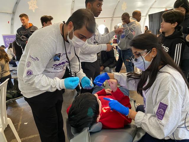 Stony Brook School of Dental Medicine students provide oral healthcare services at Suffolk County Dental Society's Give Kids A Smile event.
