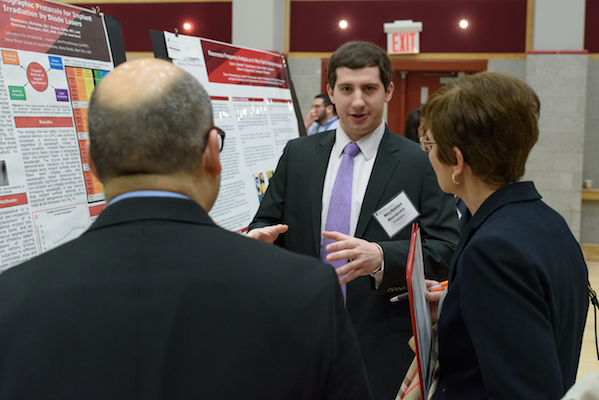 Dr. Nicholas Montanaro, Class of 2019, discusses his research poster with two faculty members at Stony Brook University School of Dental Medicine's 2019 Leo and Mickey Sreebny Lectureship and School of Dental Medicine Research Symposium